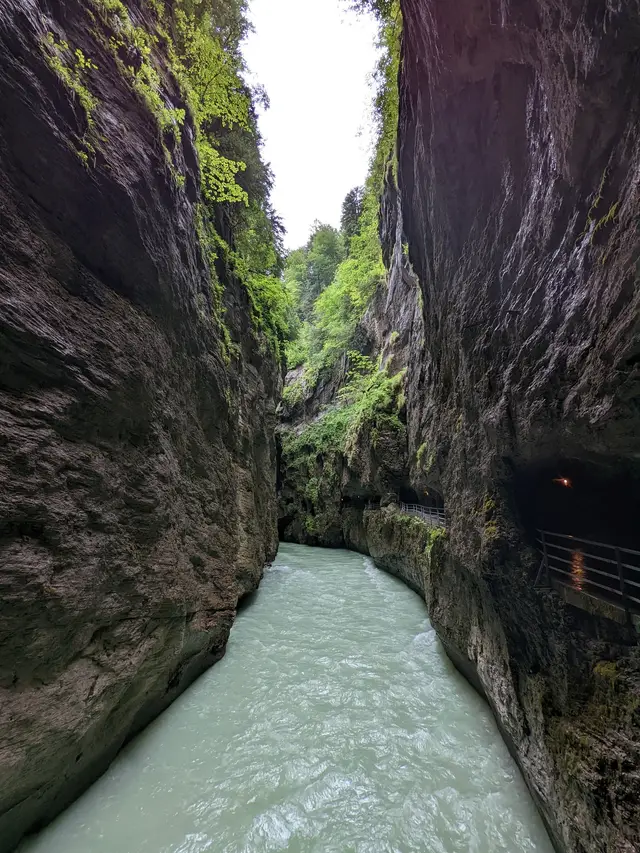 The green water between the walls, walkway on the right