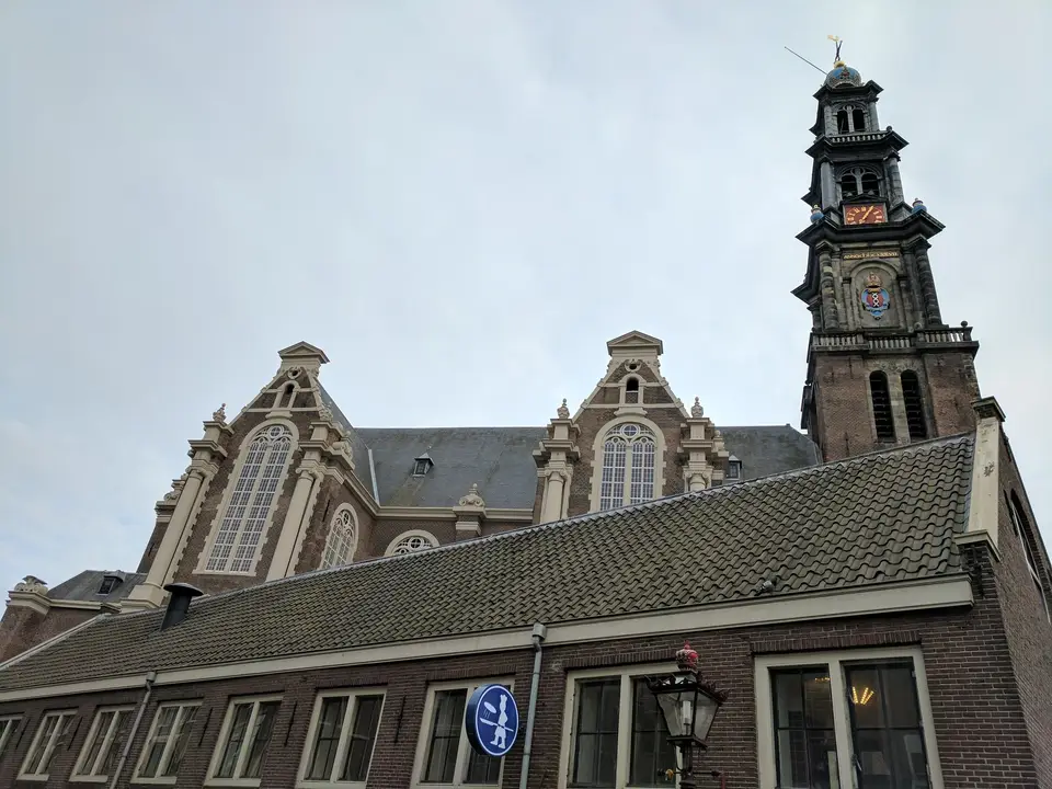The Westerkerk tower above the canal houses