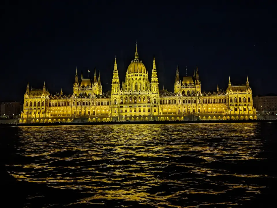 The Parliament lit up, reflected in the river