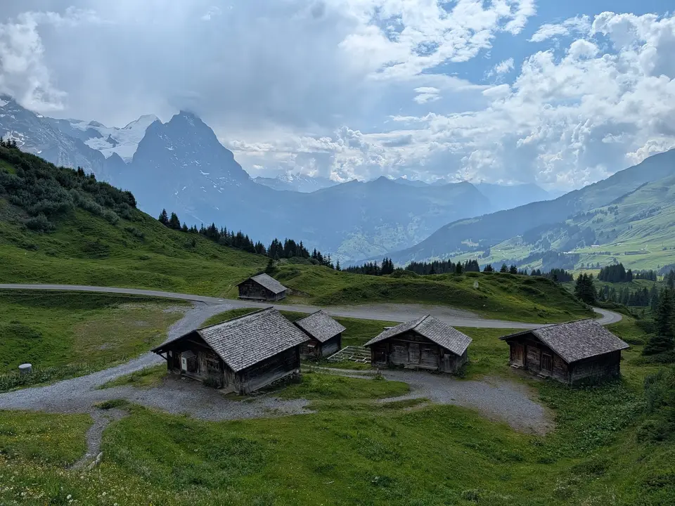 Timber barns at Bort, the Eiger behind in cloud