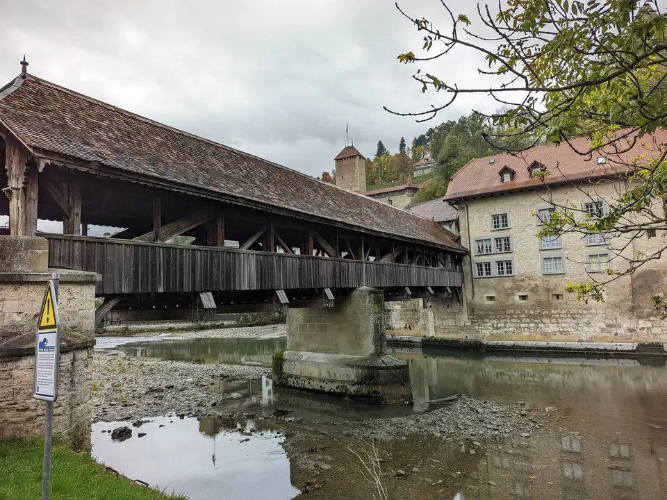 The Pont de Berne, dark timber over green water