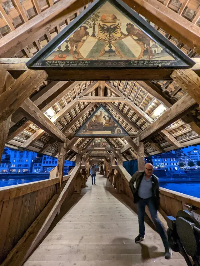 Inside the Chapel Bridge, under its painted roof panels