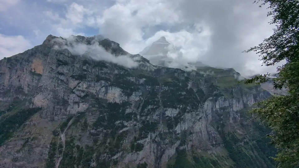 The rock wall opposite, cloud tearing over it