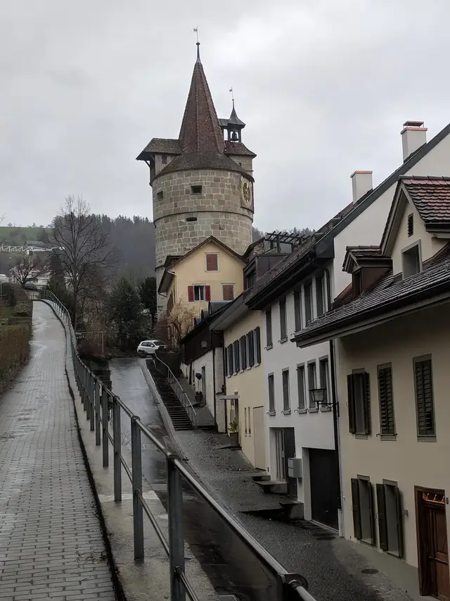 A tower of the old town wall above the lane