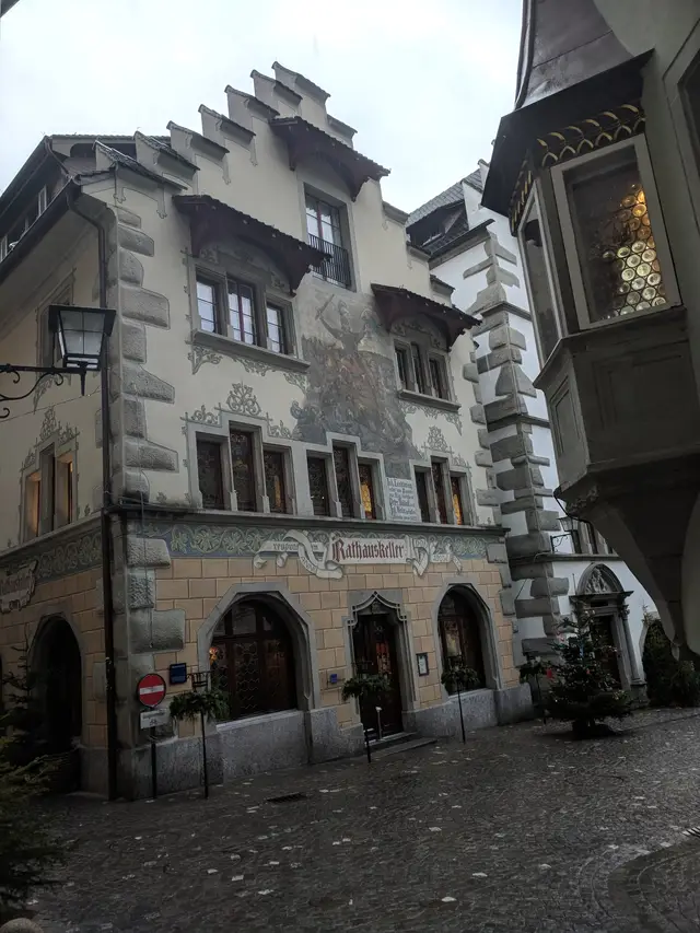 A painted house front with an overhanging bay